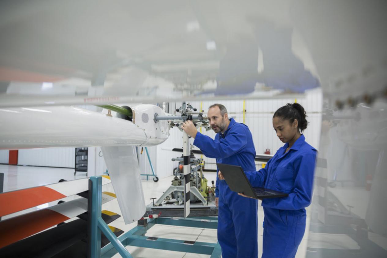 Aerospace manufacturing team inspecting an aircraft component