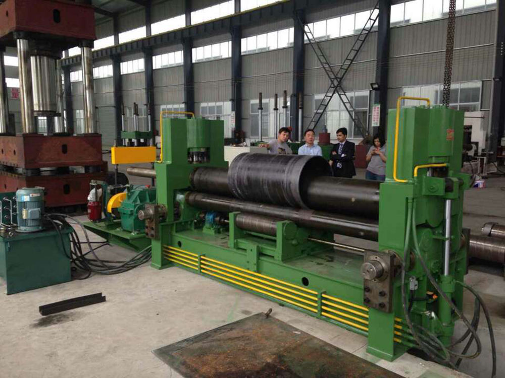 Large industrial three roll plate bending machine forming a steel shell