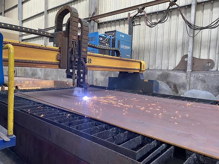 Plasma torch cutting a steel plate