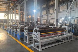 Row of symmetrical three-roll plate rolling machines on a workshop floor