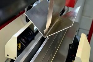 Sheet metal bending in progress between the punch and die of a press brake