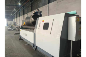 W12-12x2500 four-roll plate rolling machine forming a cylinder with an operator at the machine